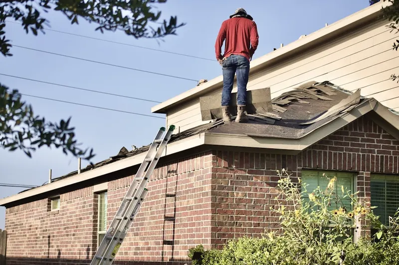 Professional roofer working on a residential roof in Eagle Heights